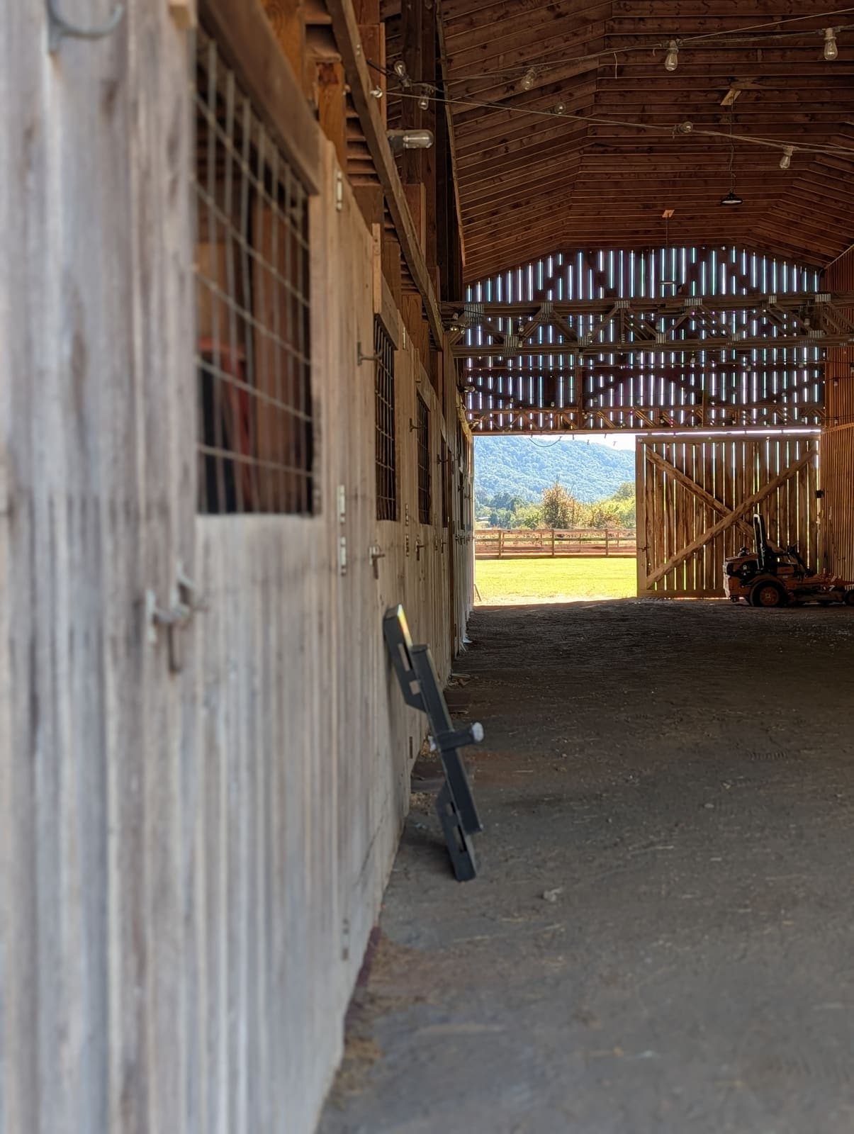 The River Creek barn aisle with its big doors open to the pasture