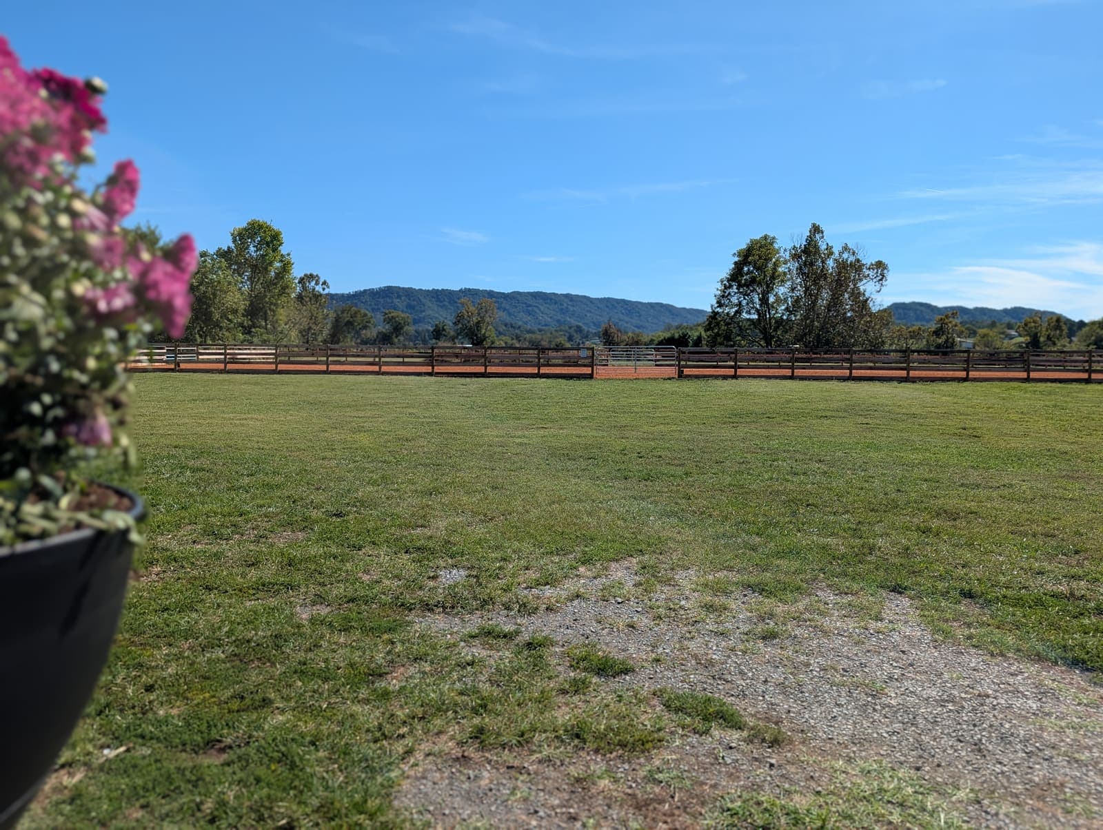 The River Creek riding arena and pasture beneath the mountains